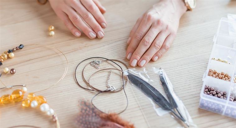 cropped-shot-of-woman-with-beads-and-threads-for-h-SDET832.jpg